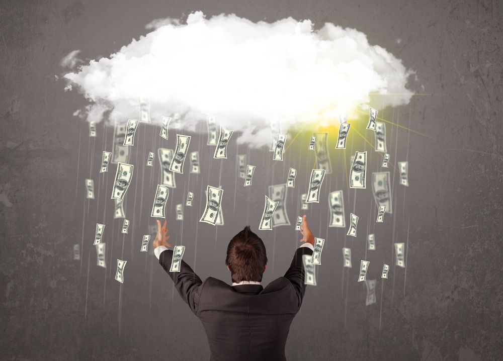 Business man in suit looking at cloud with falling money and sun Business man in suit looking at cloud with falling money and sun