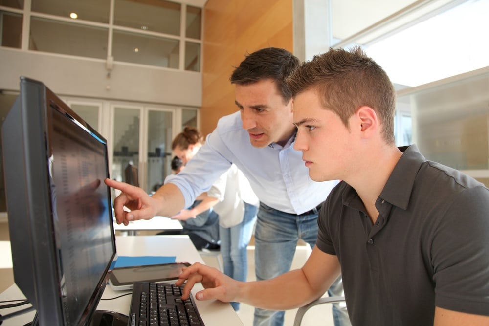 Teacher and student working on computer Teacher and student working on computer
